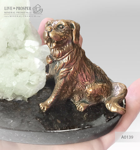Bronze figure of a dog breed St.Bernard with green quartz on a dolerite plate