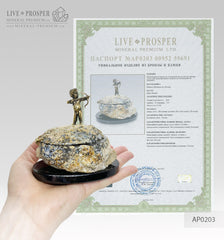 Bronze cupid on a stone agate geode box for an engagement ring on a dolerite plate