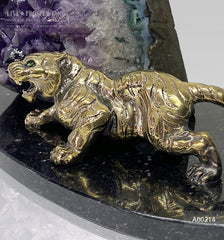 Handmade bronze tiger figure with demantoid inserts and geode's amethyst druzy background at dolerite plate 