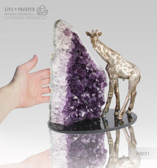 Gift Minerals with Bronze Bronze giraffe figure with amethyst on dolerite plate 