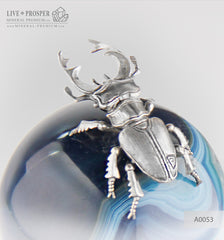  Silver figure of beetle deer on agate sphere and a dolerite plate  Серебренный жук олень на сфере из агата на пластине из долерита  Silver figure of beetle deer on agate sphere and a dolerite plate silver 925 Серебренный жук олень на сфере из агата на пластине из долерита серебро 925 проба