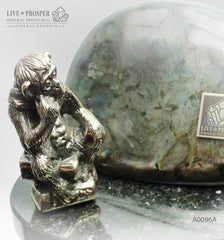 Bronze figure of monkey philosophy with labradorite on dolerite plate