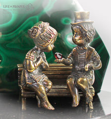Bronze cupid and sweethearts with garnet heart and malachite background