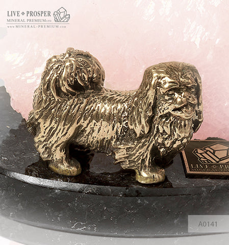Bronze figure of a dog breed Pekingese with pink calcite on a dolerite plate