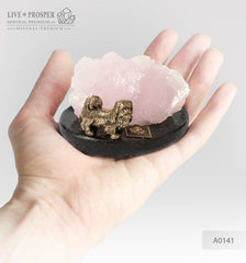 Bronze figure of a dog breed Pekingese with pink calcite on a dolerite plate