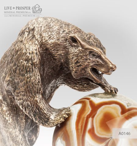 Bronze figure of bear with agate sphere on a dolerite plate