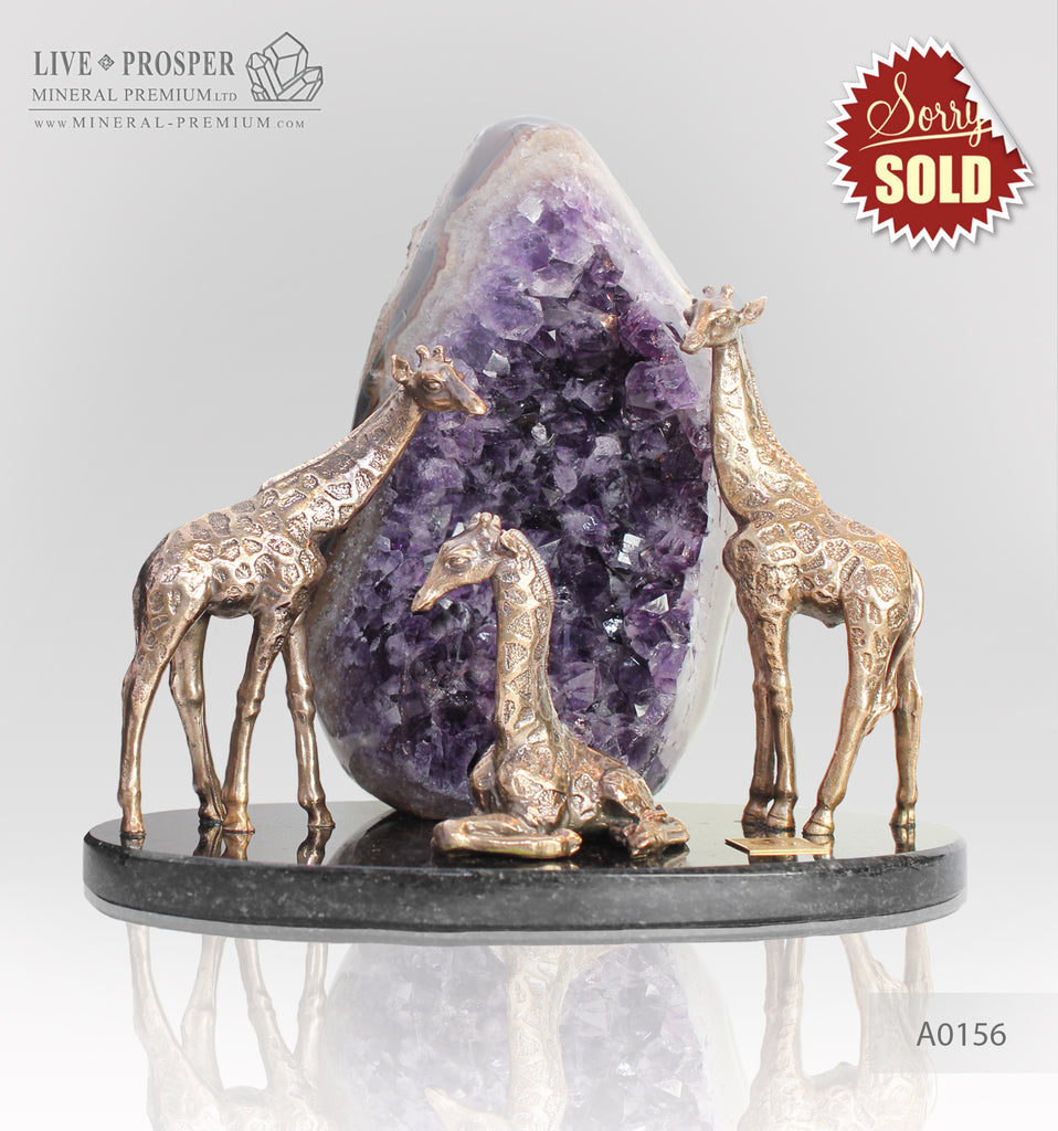 Bronze giraffes family with agate geode amethyst on a dolerite plate