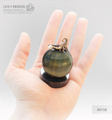 Bronze figure of scorpion on a Chrysoberyl sphere with sea pearl and Swarovski inserts on dolerite plate extra small  Бронзовый скорпион на сфере из кошачьего глаза с морской жемчужиной и вставками из Сваровски на пластине из долерита -малый
