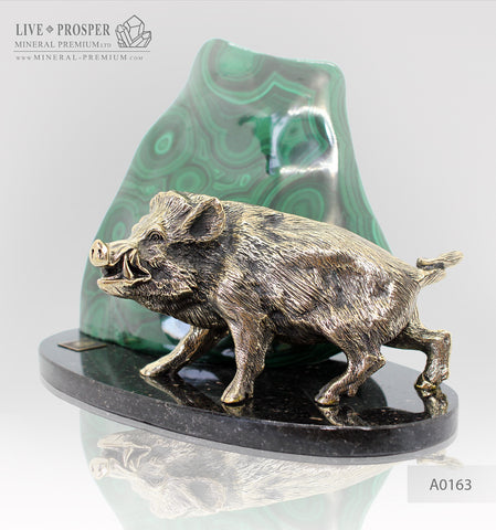 Bronze wild boar with malachite on a plate of dolerite