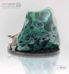 Bronze wild boar with malachite on a plate of dolerite
