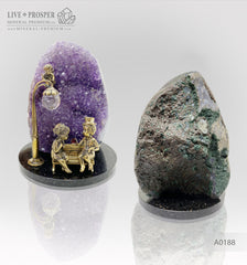 Bronze figures of cupid and sweethearts on a bench with a garnet heart on geodes amethyst agate background