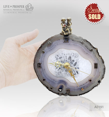 Clock with a bronze cupid figures with garnet heart on agate plate A0191