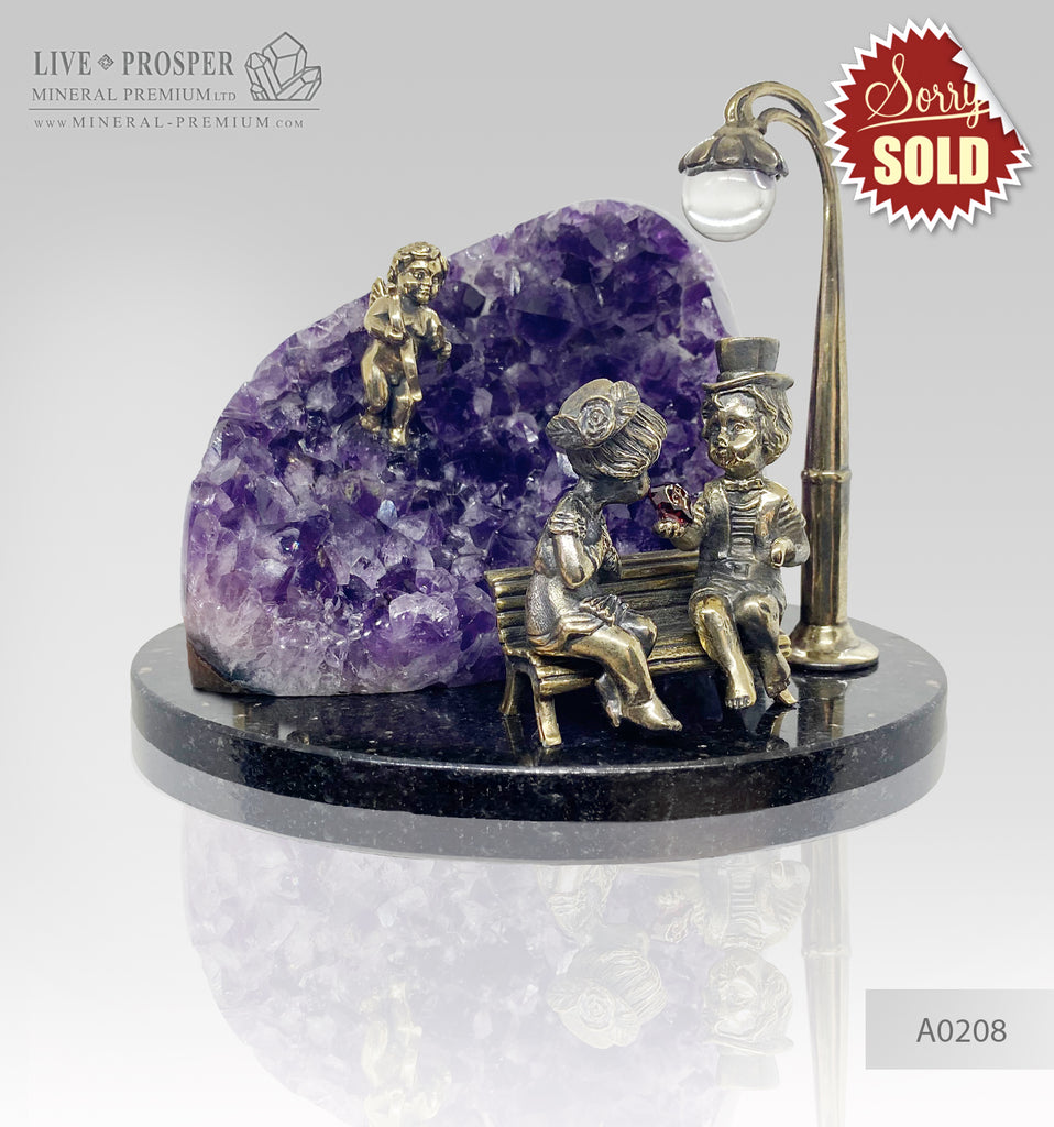 Bronze cupid and sweethearts with a garnet heart and rock-crystal sphere within bronze lantern with geode agate amethyst druzy background