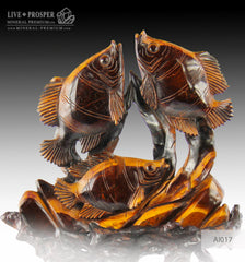 Solid tiger's eye carving of fish family playing under the sea on a wooden stand Стая рыб играющая на морском дне из тигрового глаза на деревянной подставке