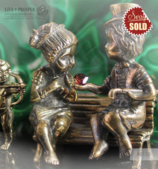 Bronze cupid and sweethearts with garnet heart and malachite background