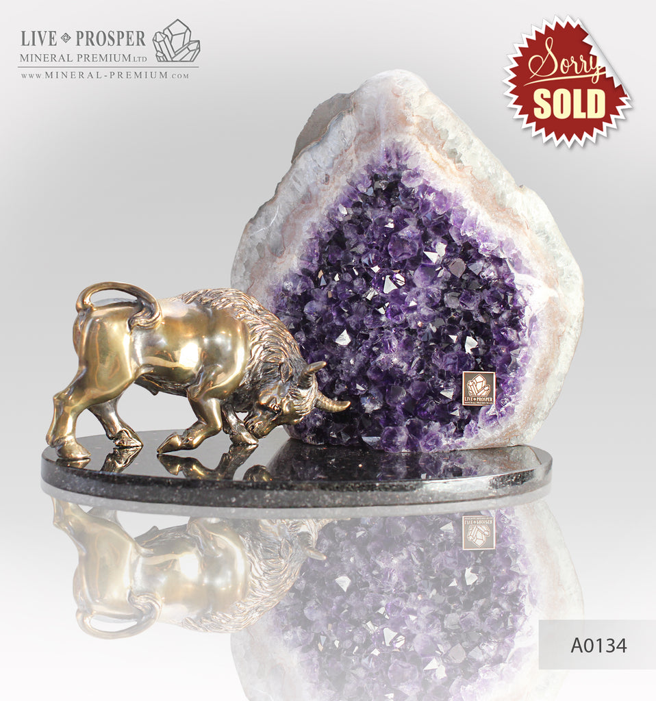 Bronze bull with agate geode amethyst on a dolerite plate