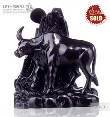 Solid obsidian carving of bull on guard - lunar calendar