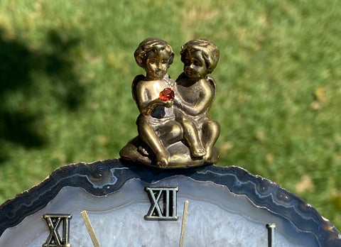 Clock with a bronze cupid figures with garnet heart on agate plate А0204A